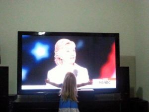 little-girl-hugging-clinton-tv-screen